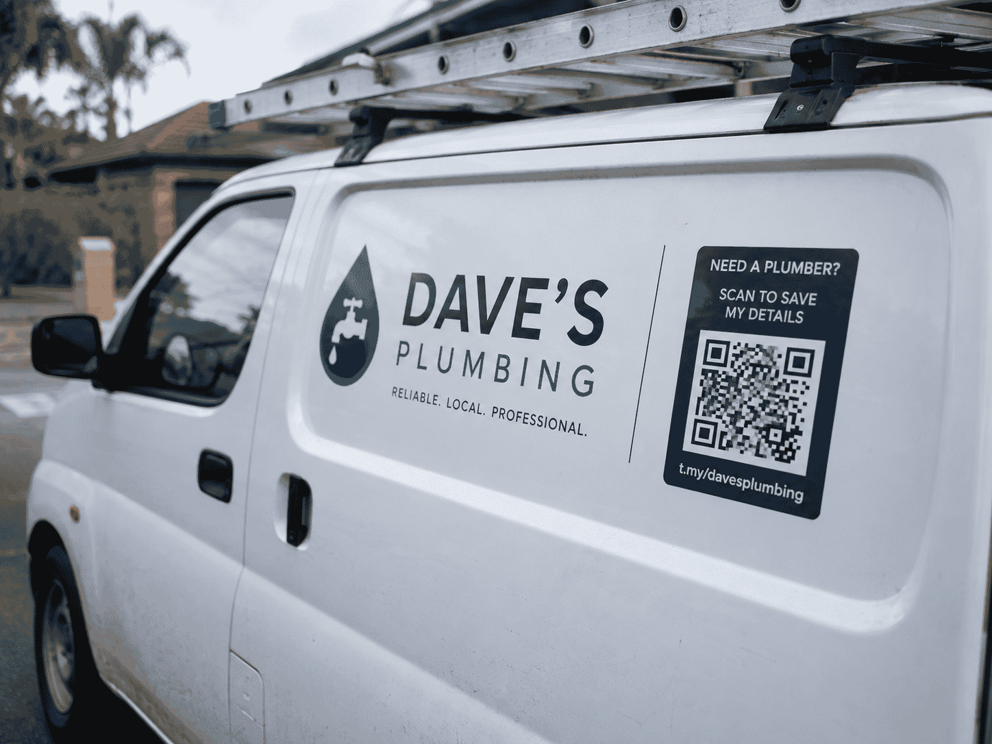 Plumber with a QR code on a work van