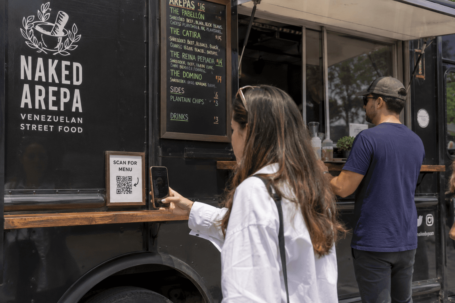 Food truck with a QR code menu sign for customers